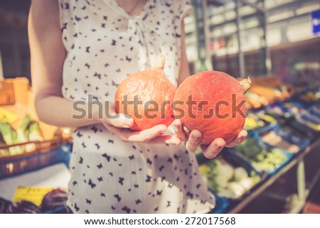 Young woman holding fresh vegetables from the harvest