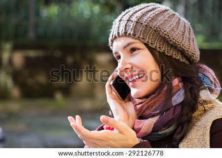 Young woman talking on cellphone outdoors. Travel, technology and communication.