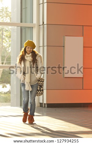 Asian stylish girl in train station walking