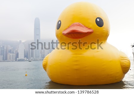 HONG KONG - MAY 6: The rubber duck swim in Victoria Harbour on May 6 2013. Giant \'Rubber Duck\' Sculpture By Artist Florentijn Hofman, visit Hong Kong which draw the attention of local.
