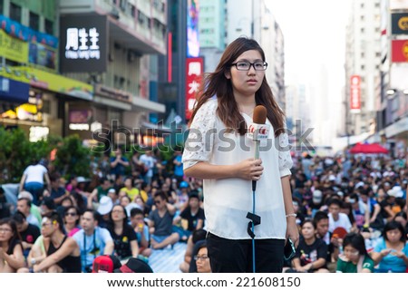 HONG KONG, OCT 1: Crowd of protesters occupy the road in Mongkok on 1 October 2014.  The reporter is reporting news at the occupying location.