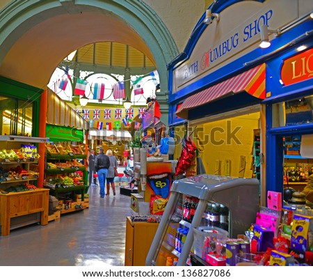BATH, ENGLAND-MARCH 30: Tourists and locals shop the historic Guildhall Market on March 30, 2013. The market has been serving the community for around 800 years.