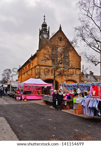 MORETON IN THE MARSH-APRIL 9: People shopping  at the weekly market held at the old market building on April 9, 2013. Moreton in the Marsh is one of the principal market towns in northern Cotswolds.
