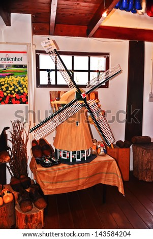 ROTTERDAM, NETHERLANDS-APRIL 14: A windmill display catches the attention of people shopping on April 14, 2013. The windmill has been an important part of keeping water from the land of Holland.