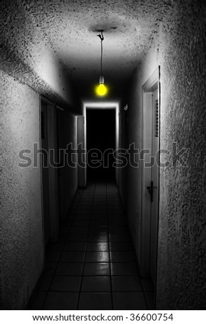 Yellow light glowing in dark underground corridor.