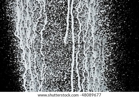White paint splashed over black background. Abstract texture.