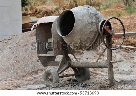 Industrial cement mixer machine at construction site.