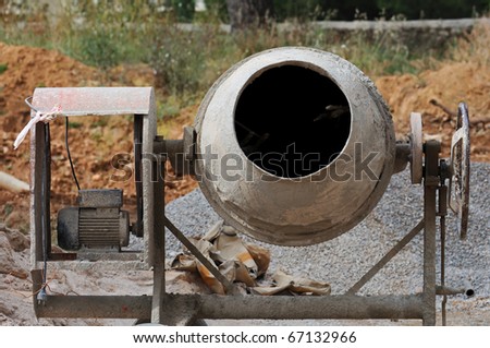 Industrial cement mixer machinery at construction site.