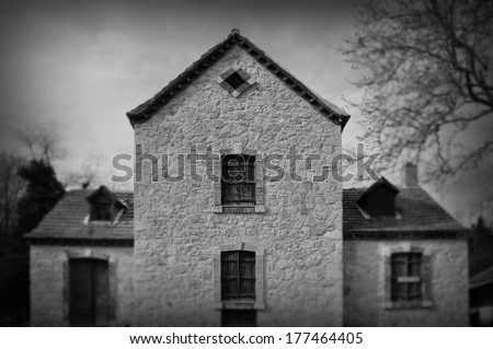 Gothic revival architecture abandoned house exterior abstract blur. Black and white.