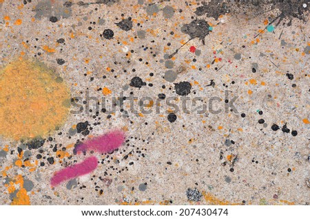 Colorful paint stains on concrete abstract artistic background texture.
