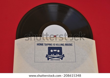 ATHENS, GREECE - AUGUST 1, 2014: Vinyl record inner sleeve with 1980s anti copyright infringement campaign skull and crossbones with cassette tape head. Home taping music piracy.