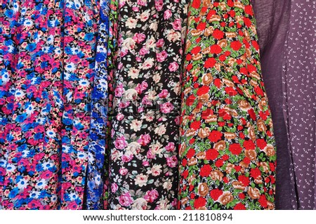 Old fashioned garments with floral pattern abstract textile colorful fabric background texture.