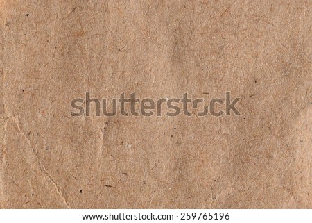 Brown paper with fibers and crease abstract background texture.