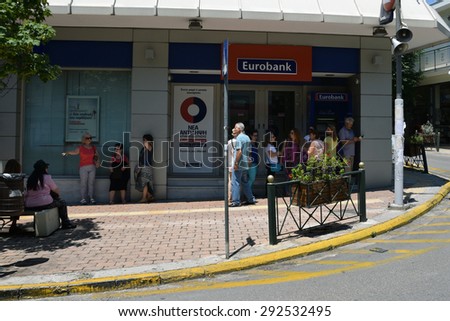 ATHENS, GREECE - JULY 1, 2015: People patiently waiting at ATM cashpoint queue. Banks are closed and capital controls implemented allow a daily cash money withdrawal of 60 euro. Greek debt crisis.