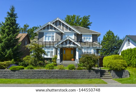 Luxury family house with landscaping and blue sky background. Canada.