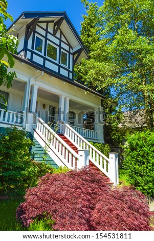Front porch of big house with steep stairs at the entrance. Fragment of big family house in suburb of Vancouver, Canada.
