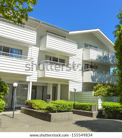 Low-rise apartment building in suburb of Vancouver, Canada. Apartment building on a sunny day with blue sky background.