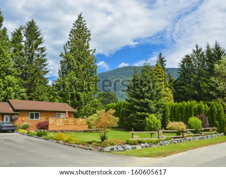North American family house on country side. Single house with landscaping on the front and blue sky background.
