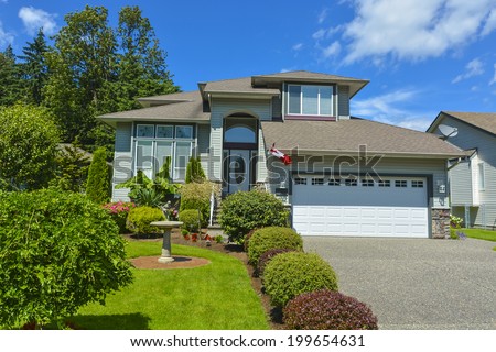 Residential house with garage on blue sky background.