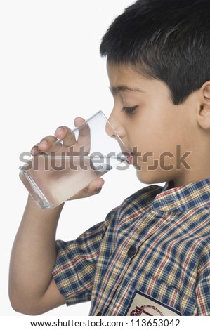 Schoolboy drinking a glass of water