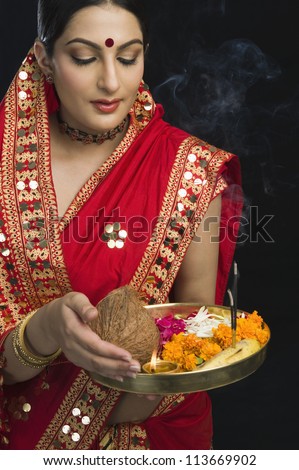 Woman in sari holding religious offering