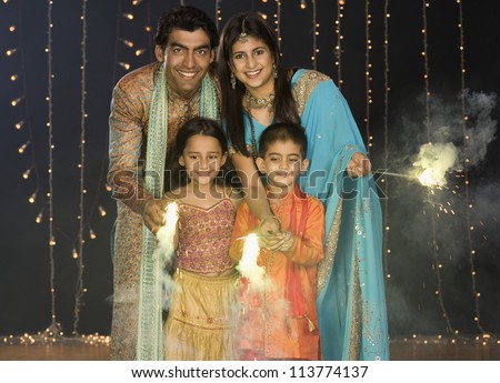 Family celebrating Diwali festival Family celebrating Diwali festival