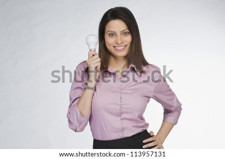 Businesswoman holding a light bulb and smiling