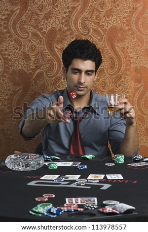 Man throwing dices on a table
