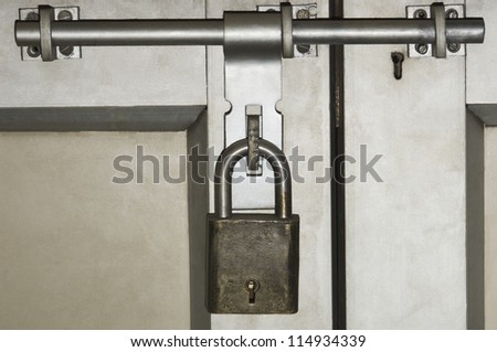 Close-up of a door locked with a padlock