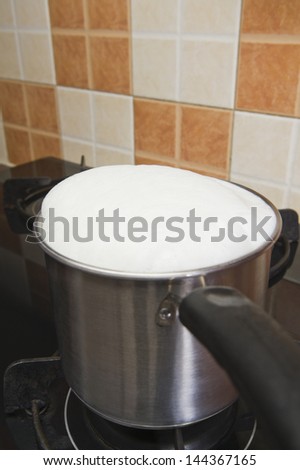 Milk boiling over a pan