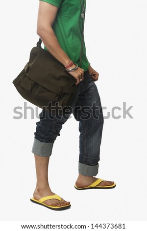 Low section view of a university student carrying a bag