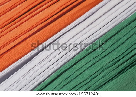 Close-up of a stack of colorful papers representing Indian flag colors