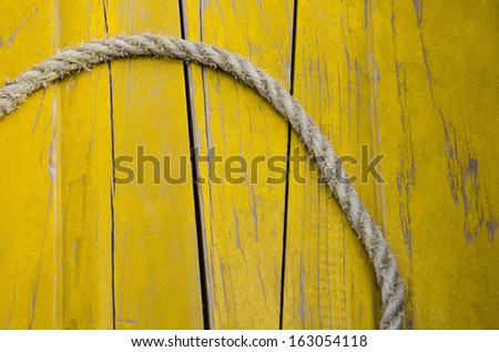 Rope against yellow wood planks, India