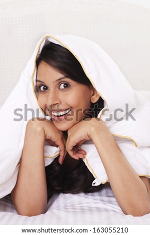 Woman covering herself with a bedsheet