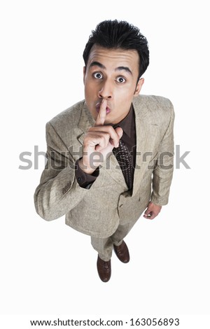 Portrait of a businessman with his finger on lips