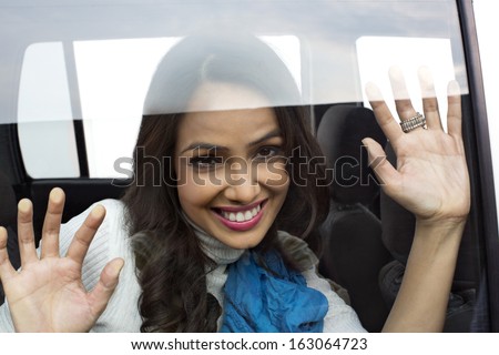 Smiling woman looking out the window of a car