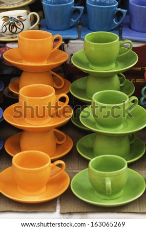 Display of tea cups with saucers for sale at market stall