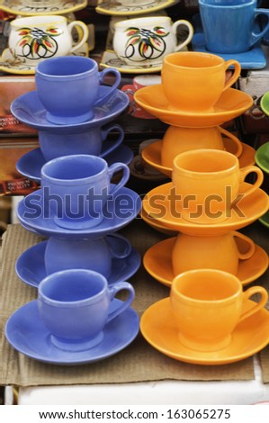 Display of tea cups with saucers for sale at market stall