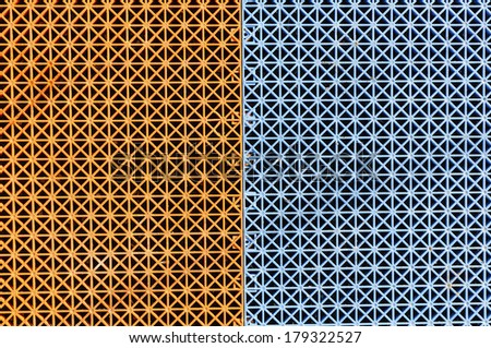 Plastic grid texture separated in two halves ,orange and blue part of alley