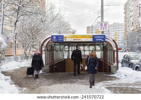 Bucharest, Romania - December 30, 2014: People crossing Dristor 2 subway station entrance in a cold freezing winter day