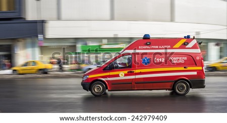 BUCHAREST, ROMANIA - FEBRUARY 10, 2014: First aid car belonging to SMURD, a romanian emergency rescue service, driving very fast on city street due to an emergency call.