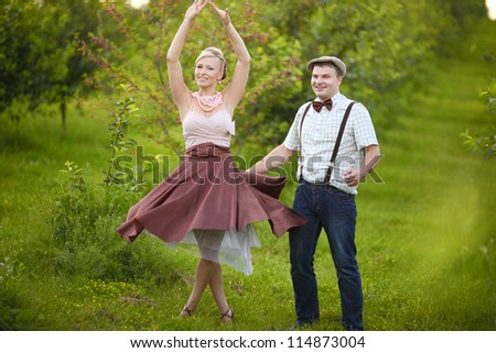 Young couple in love dancing in the park