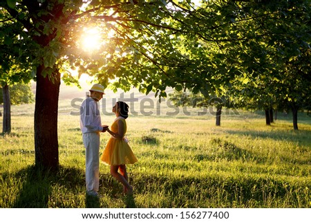 man and woman in sunset inthe park