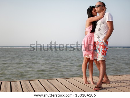Happy Beautiful Couple Looking The Horizon And The Future Together At Beach