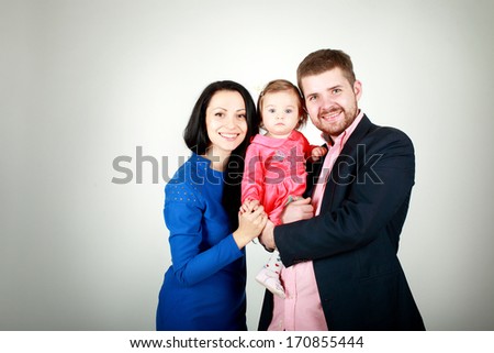 Portrait of happy family of three persons on a white background