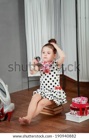 cute smiling little girl with makeup brush