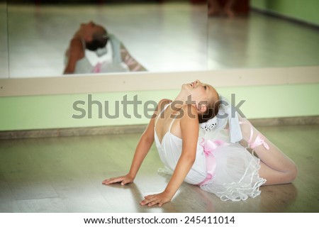 Young ballerina in tutu showing her techniques