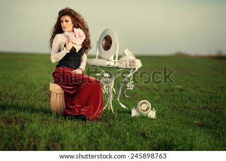 Fairy woman sitting near the table outside