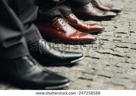 Men\'s legs in shoes on the street