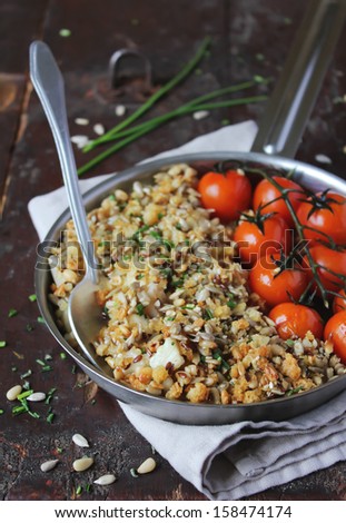 Baked cod fillet fish with cherry tomatoes and seeds in a pan